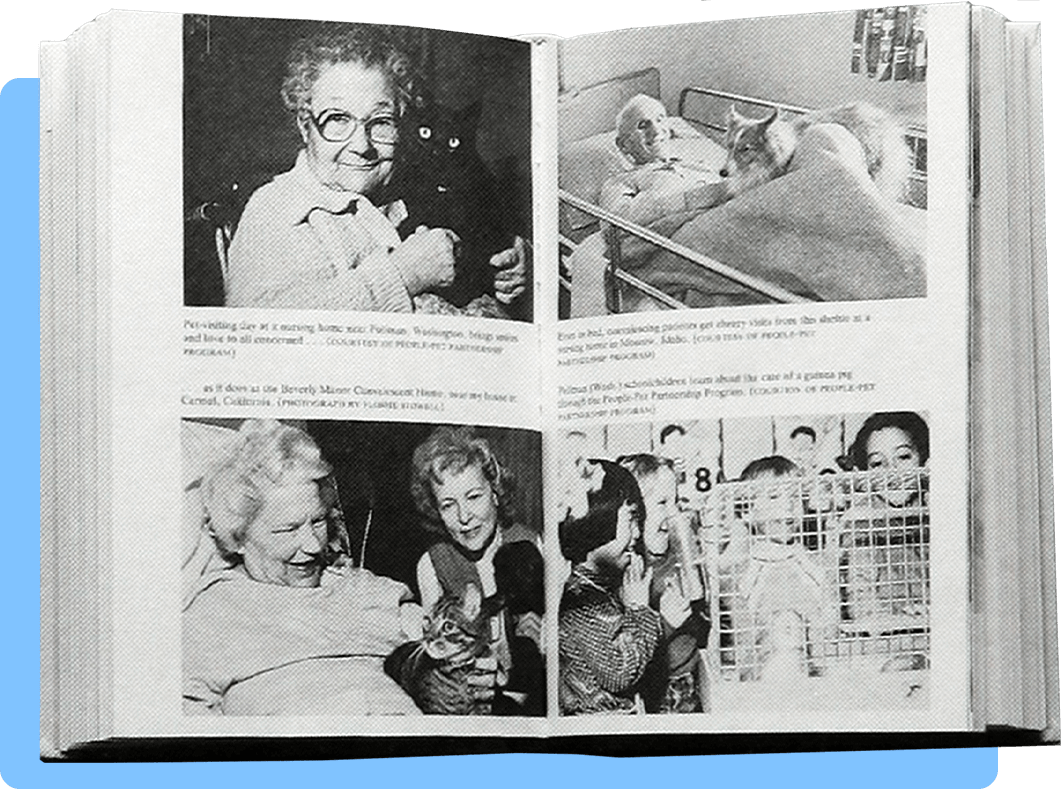 A book open to a two page spread with four photographs of patients in hospitals, hospices, and nursing homes being visited by animals 