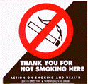 Public Health written in blue lettering below a diagonal half white half black illustration with a cigarette in the center surrounded by a red circle with a line through it. The bottom right black diagonal has Thank you for not smoking here written in white lettering.