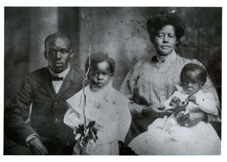 Photo of African American father, mother, and two young sons. Dr. Berry second from left at age 5.