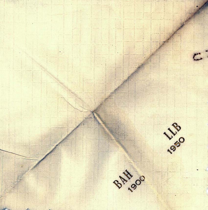 White square napkin with the initials BAH 1900 and LLB 1950.