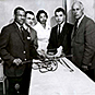 Dr. Berry holding a long rod-like tool with 3 men and a woman from the Cook County Graduate School. Handwriting on back.
