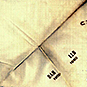 White square napkin with the initials BAH 1900 and LLB 1950.