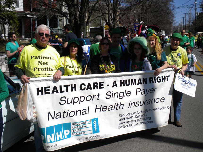 St. Patrick's day marchers wearing green and holding a banner. 