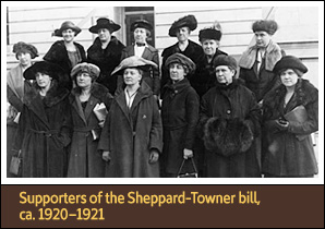 13 White women stand on steps for a picture and face slightly left of the viewer