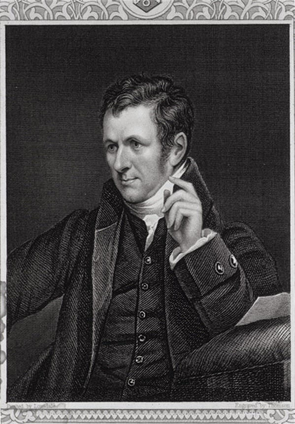A man (Humphry Davy) seated and looking to the left resting his arm on a desk.