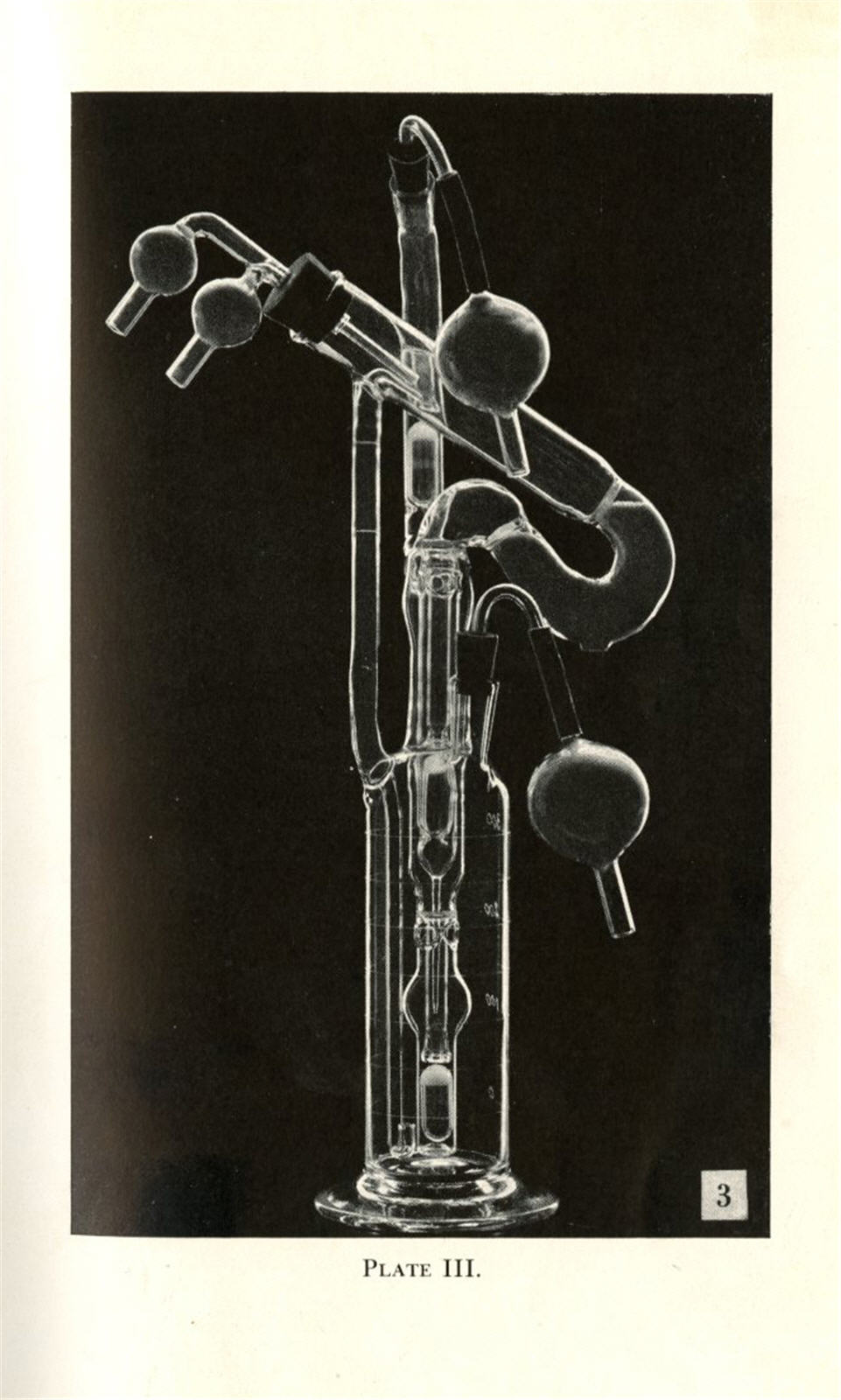 Tall, narrow, glass instrument with curved, cylindrical pipes and valves.