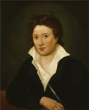 Portrait of a young man in a black garment with a white collar, looking forward.