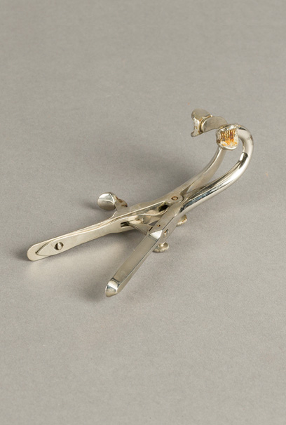  Metal mouth gag tool used to hold the mouth open during intubation procedure.
