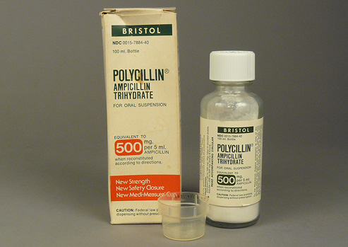 Box, bottle, and dispensing cup for oral antibiotic product.