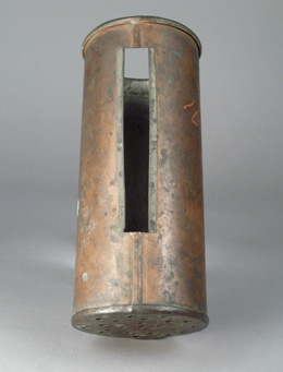 Copper cylinder with one end closed and perforated with small holes and a long rectangular window cut into one side.