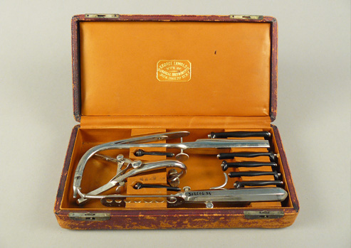 Leather covered case with lid open to show intubation tools arranged inside.