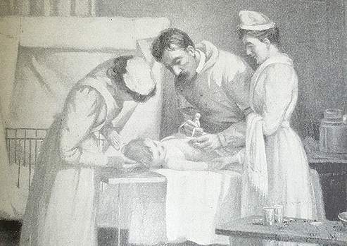 A man in gown gives an injection to a small child laying on a table.  Two women in nursing gowns and caps attend to the child at its head and side.