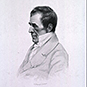 Profile view of James Jackson in a collared shirt and jacket.
