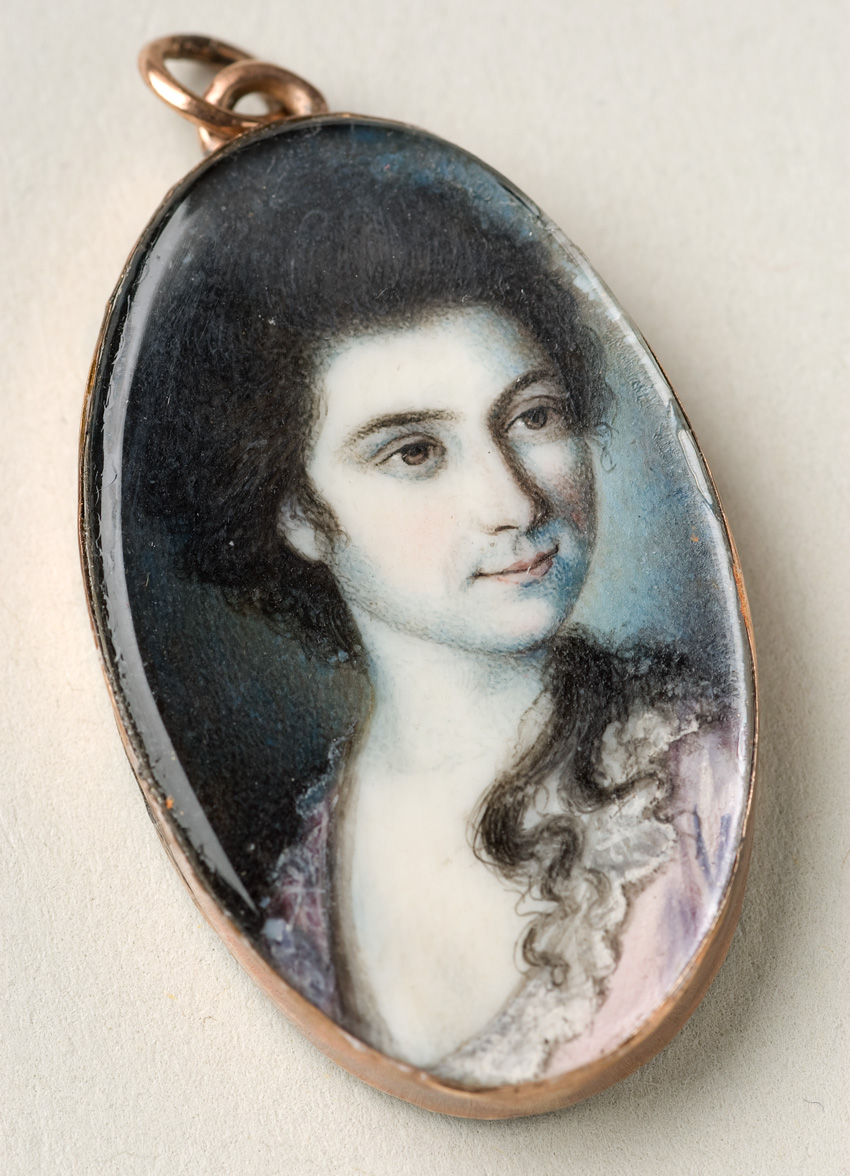 Young, brown-haired white woman wearing pink and lace clothing.