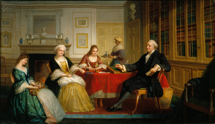 Washington Family dressed formally sitting beside a table in a room with a fireplace and bookshelf.