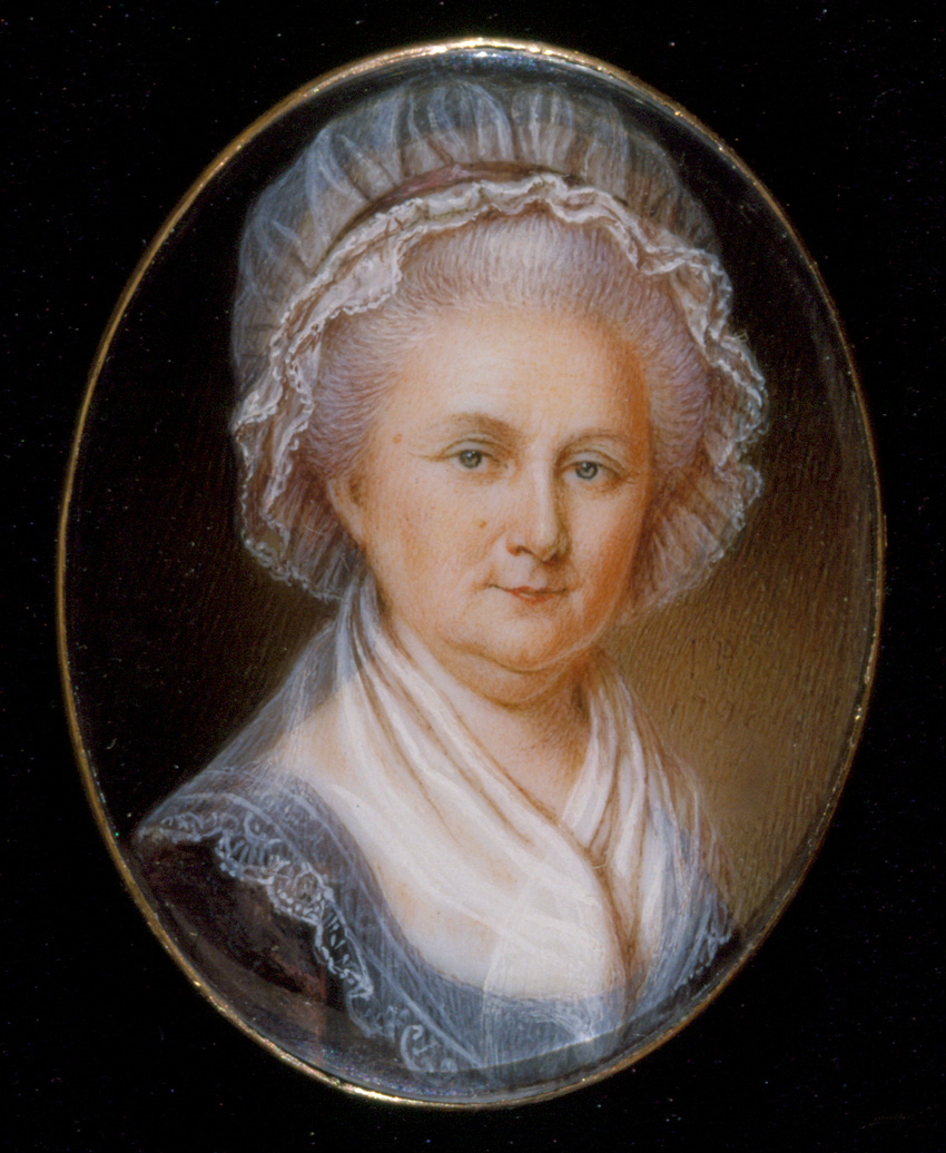 Martha Washington wearing a cap over her silver hair and a sheer shawl around neck.