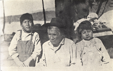 Front view of two Native American boys flanking an older Native American man that are infected with trachoma. From Contagious and Infectious Disease among the Indians, U.S. Senate Document, 1913.