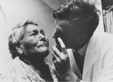 A NIAMS doctor is conducting an eye examination on a Pima woman on a reservation in Arizona, c. 1980s. 