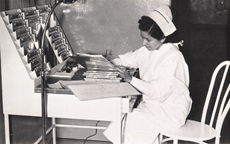 A Native American nurse is sitting at a desk working on hospital records. From Nomenclature of Diseases and Conditions and Hospital Record Manual, Office of Indian Affairs Health Division, 1943.
