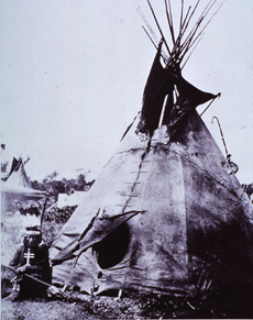 A medicine-man sitting to the left of the entrance to his tepee, 19th c.