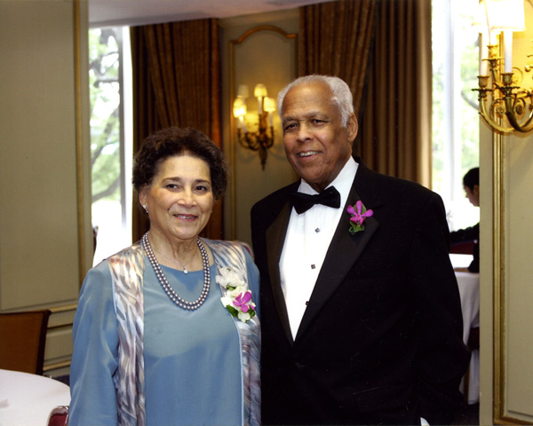 Image of a woman and man dressed in formal attire.