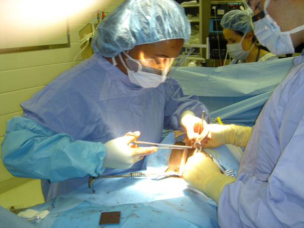 Surgeon operating on a patient.