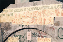 Sign on wall in English and Chinese language declaring workers must speak Chinese.