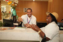 A smiling woman and man looking at a flyer in a hospital setting.