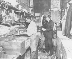 John Earnshaw, an inspector with the Bureau of Chemistry, inspecting eggs in an establishment.