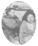 An Indian Health Service doctor listens to the lungs of an Alaska Native woman from behind.