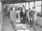 Passengers arriving from Paris at LaGuardia Airport in New York City and walking through the walk-way to the quarantine room. They are led by inspection officers Evans and Weeks.
