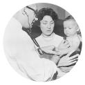 At the Naples Foreign Quarantine Station Dr. Franco Ermenegildo examines 1-year-old Elias West using a stethoscope. Mrs. Emma Germano, visa examination aide is in the center of the photograph holding Elias.