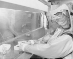 A man wearing full body protective clothing in the Centers for Disease Control and Prevention's new maximum containment virology laboratory performing an experiment.