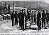 Civil war soldiers in winter are standing drinking from a barrel whiskey and quinine