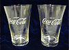 Photograph of two glasses with “Drink Coca-Cola” etched on them.