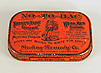 Photograph of the top of an orange anti-tobacco tin with advertisement engraved on it.