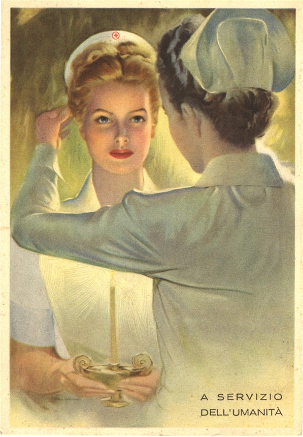 A White female nurse placing a Red Cross nurse cap on another White female nurse holding a candle.