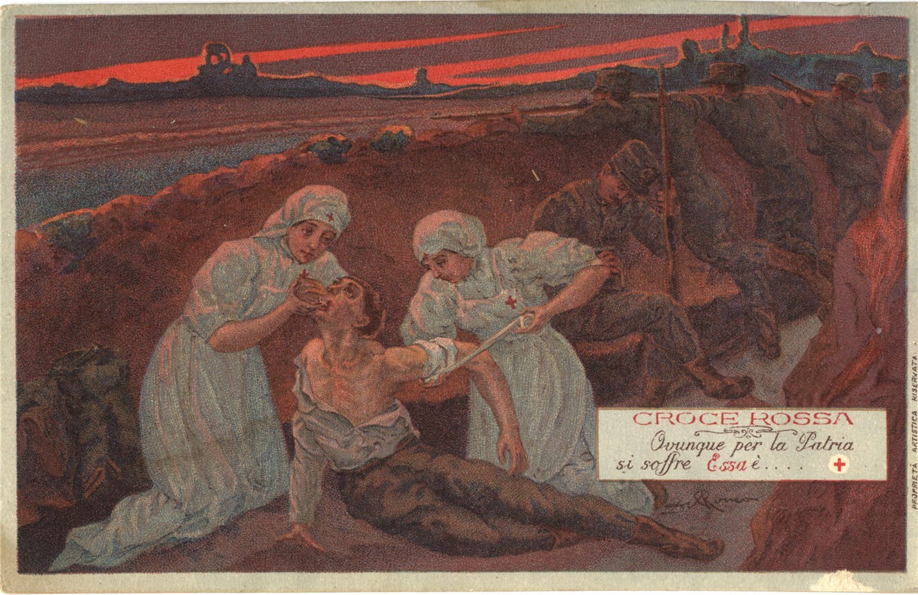 Two White female nurses in a trench, aiding a wounded White male soldier.