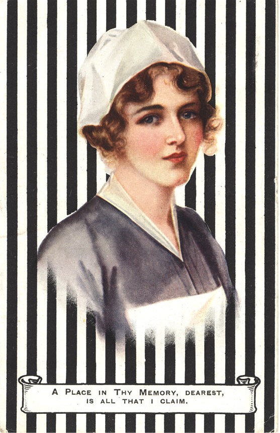 A White female nurse in blue and white, visible from the chest up, looking at the viewer.