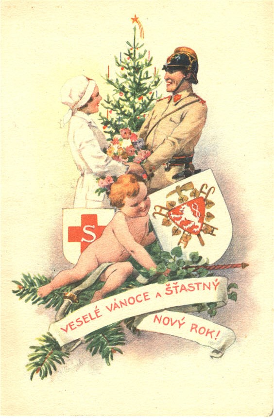 A White female nurse and White male fireman holding hands before a Christmas tree.