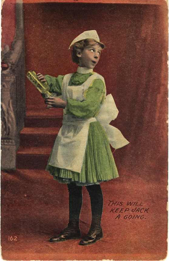 A White girl in a green and white nurse uniform pouring castor oil into a glass.