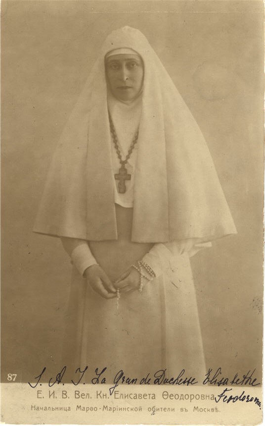 A White female nurse nun (Duchess Elizabeth) in her full habit, looking at the viewer.