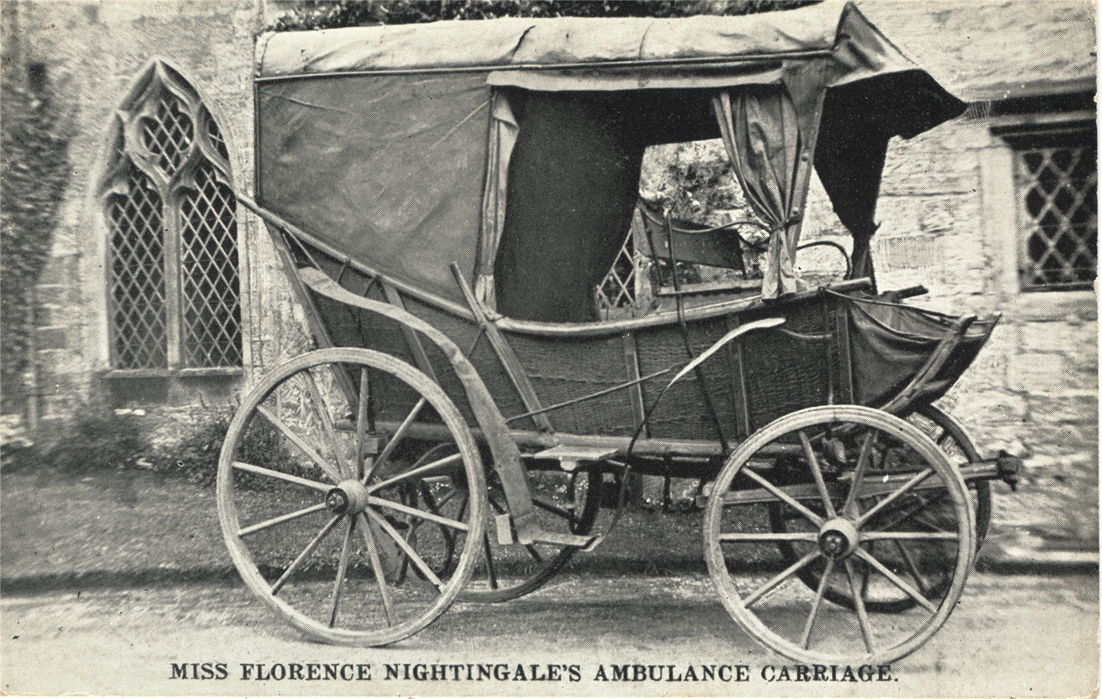 Florence Nightingale's ambulance carriage, parked outside of a stone church.