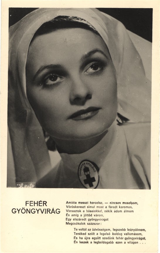 Portrait of a White woman (Vali Rácz) dressed as a nurse, looking up and to the right.