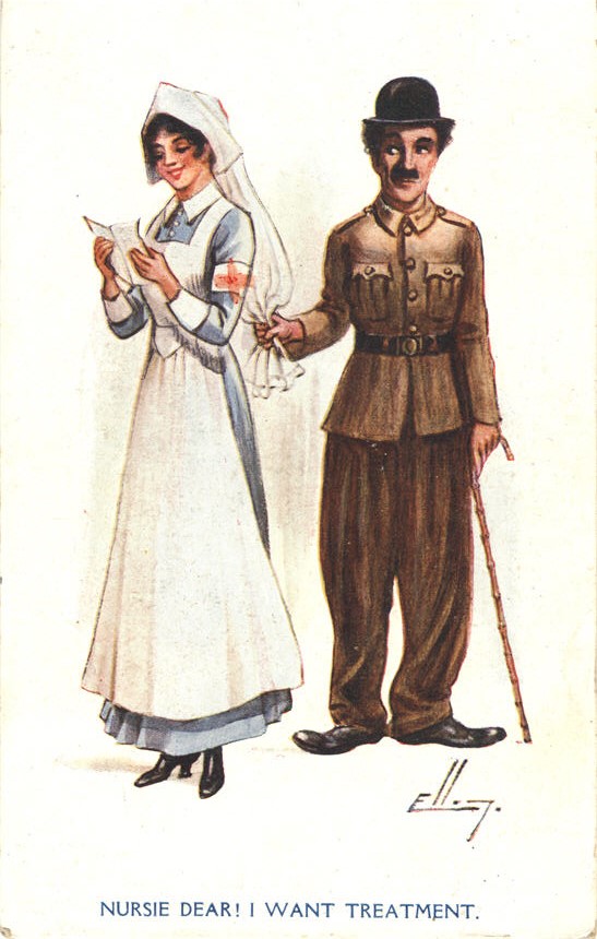 A White man (Charlie Chaplin) tugging on a White female nurse's headdress as he stands behind her.