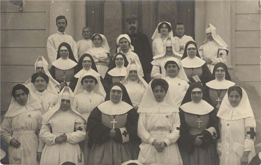 Large group of White nun nurses and doctors in front of a hospital.