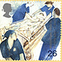 Three White females and one White male nurse, all in blue scrubs around a patient in a rolling bed.