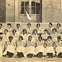 Twenty-six African American female nursing students sitting on steps.