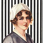 A White female nurse in blue and white, visible from the chest up, looking at the viewer.