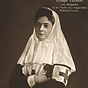 A White female (Queen Eleonore) in a head covering with the Red Cross symbol on her arm.